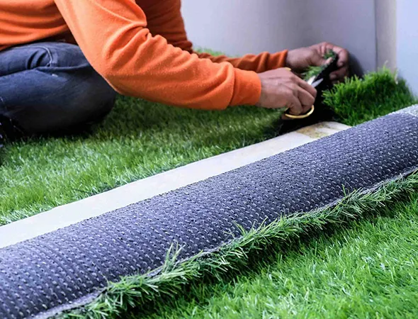 Low-maintenance synthetic grass covering a church entryway walkway