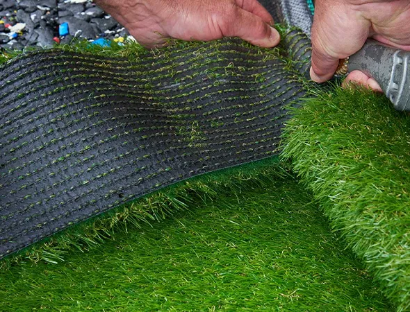 Children playing on church playground turf with safety padding underneath