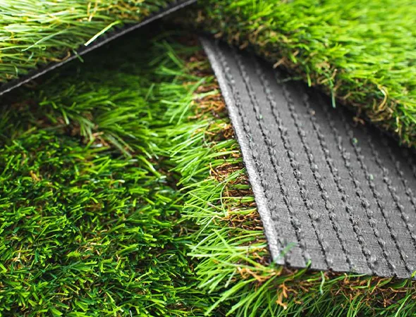 Close-up of durable artificial turf blades installed on church grounds