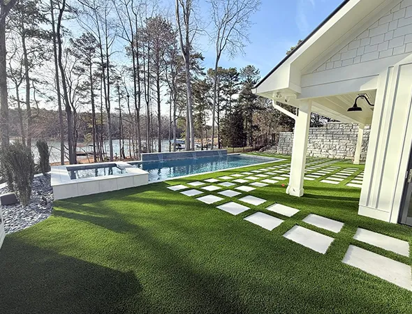 Pool area turf installation with clean drainage around swimming pool