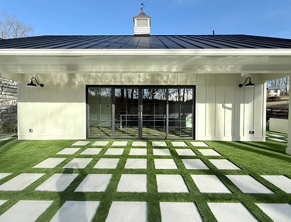 Residential swimming pool surrounded by professionally installed turf