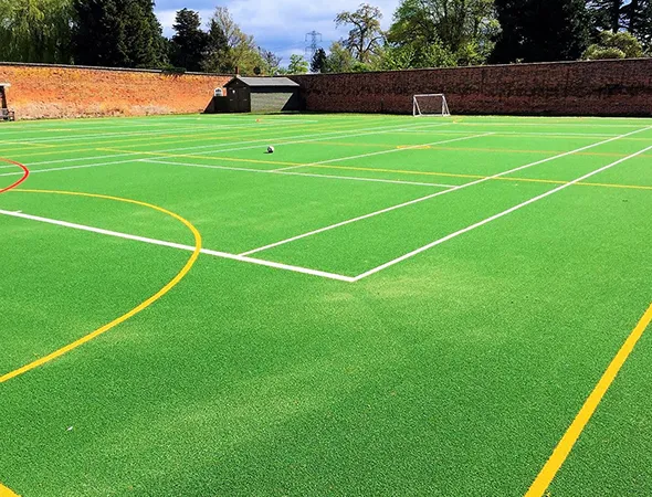 Artificial grass installed around a school play area and walkway